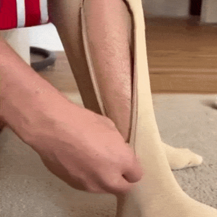 Person struggling to put on regular compression socks