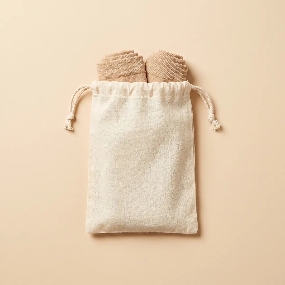 Zipleek Travel Pouch — holding two pairs of rolled beige compression socks