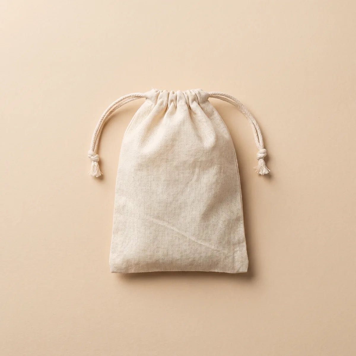 Zipleek Travel Pouch — natural cotton muslin drawstring bag laid flat