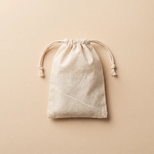 Zipleek Travel Pouch — natural cotton muslin drawstring bag laid flat